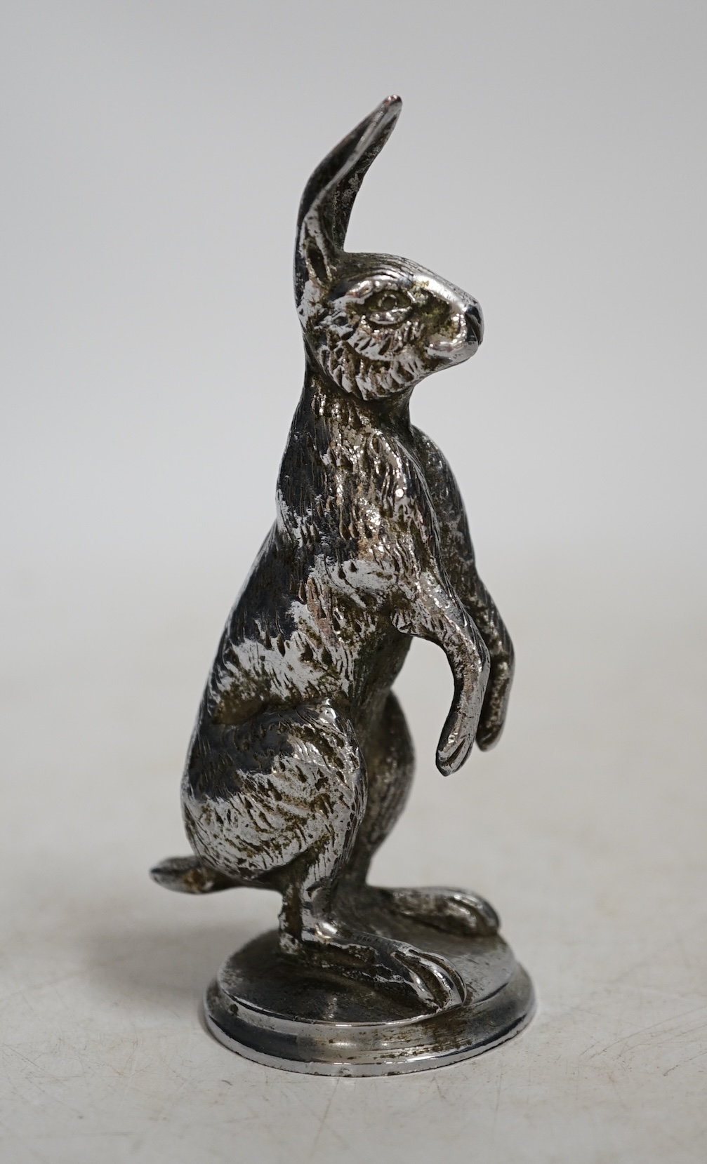 A mid 20th century chromed metal hare car mascot, 11cm high. Condition - good